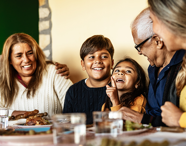 Happy Latin family having fun lunching together at home