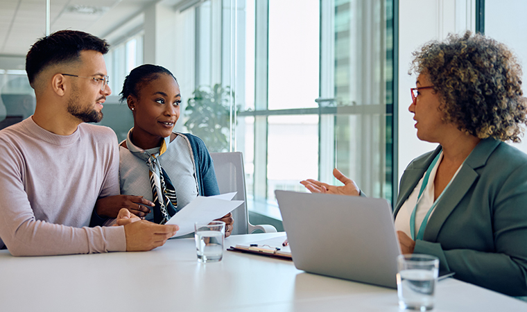 Young multiracial couple having consultations with their financial advisor in office